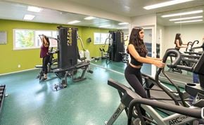 Gilroy apartment for rent - Two women working out on exercise machines in a gym.