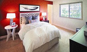 Cupertino apartment for rent - a bedroom with a bed and a red wall