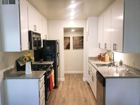 Mountain View apartment for rent - a renovated kitchen with white cabinets and stainless steel appliances