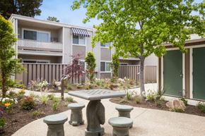 Santa Clara apartment for rent - a courtyard with a table and benches in front of an apartment building