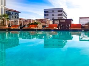 San Mateo apartment for rent - A pool with a reflection of the buildings around it.