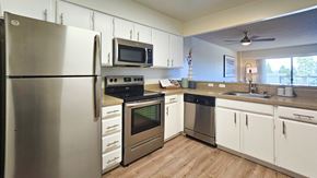 San Mateo apartment for rent - A modern kitchen with stainless steel appliances and white cabinets.
