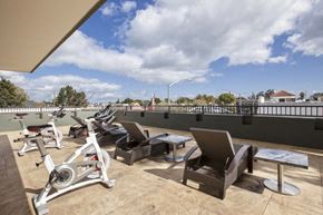 San Mateo apartment for rent - a rooftop gym with exercise bikes and benches