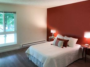 Campbell apartment for rent - a bedroom with a white bed and a red wall