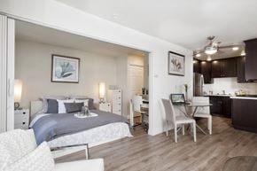 Mountain View apartment for rent - a bedroom with a bed and a desk and a living room