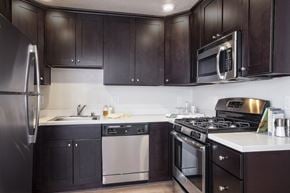 Mountain View apartment for rent - a kitchen with stainless steel appliances and dark wood cabinets