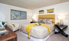 Mountain View apartment for rent - a bedroom with a large bed and a yellow blanket
