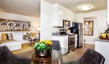 Mountain View apartment for rent - a living room and kitchen with a glass table