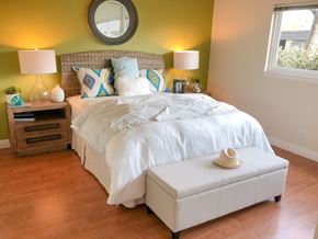 Cupertino apartment for rent - A bedroom with a white bed and a hat on the ottoman.