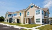 Cecilton apartment for rent - the exterior of a home with tan siding and blue windows
