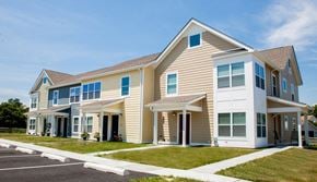 Cecilton apartment for rent - the exterior of a home with tan siding and blue windows