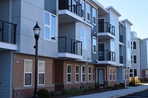 Wood-Ridge apartment for rent - a row of apartments with balconies and a street light