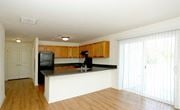 Burlington apartment for rent - a kitchen with a counter and a black refrigerator