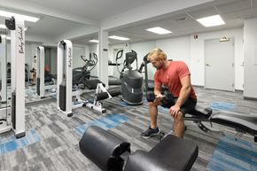 Cincinnati apartment for rent - a man working out in the gym