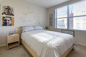 Cincinnati apartment for rent - a bedroom with a bed and two large windows