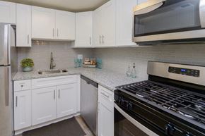 Reisterstown apartment for rent - a white kitchen with stainless steel appliances and white cabinets