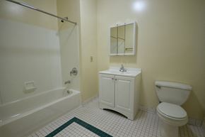 Orange apartment for rent - bathroom with white cabinet, white tile floor, and off white walls