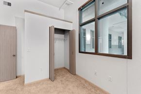 Omaha apartment for rent - a bedroom with a large window and a door to a closet