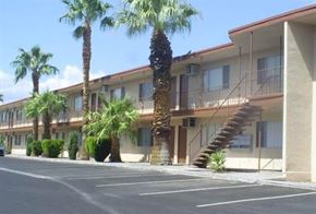 Las Vegas apartment for rent - a building with palm trees in front of it