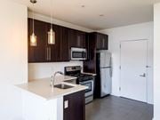 Jersey City apartment for rent - a kitchen with stainless steel appliances and wooden cabinets