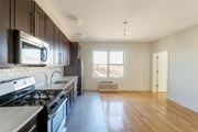 Jersey City apartment for rent - an empty kitchen with a stove and a window