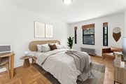 Jersey City apartment for rent - A bedroom with a bed, a desk, a chair, and a plant.