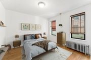 Jersey City apartment for rent - A bedroom with a bed, nightstands, and a window with blinds.