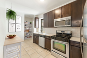 Jersey City apartment for rent - A kitchen with a white stove top oven and a microwave above it.
