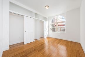 Jersey City apartment for rent - a living room with wood floors and white walls and a window