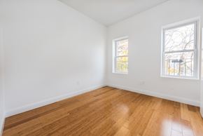 Jersey City apartment for rent - an empty room with wood floors and two windows