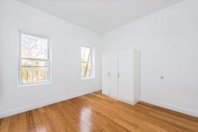 Jersey City apartment for rent - a living room with white walls and wood floors and a closet