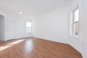 Jersey City apartment for rent - an empty living room with wood floors and white walls