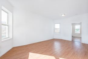 Jersey City apartment for rent - an empty living room with wood floors and white walls