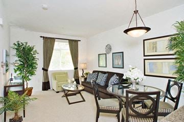 Los Angeles apartment for rent - A living room with a brown couch and a glass table.