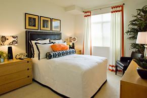 Los Angeles apartment for rent - A bedroom with a large bed, a nightstand, and a chair.