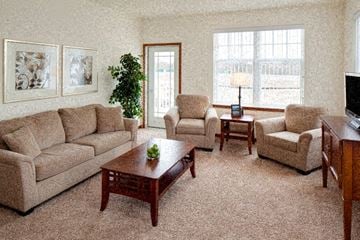 Wales apartment for rent - a living room with couches and chairs and a television