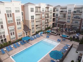 Cincinnati apartment for rent - an aerial view of a swimming pool in front of an apartment building