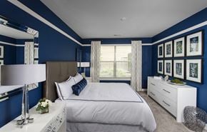 Cincinnati apartment for rent - a bedroom with blue walls and a white bed
