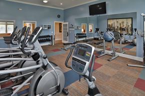Fairborn apartment for rent - a gym with exercise equipment and a television