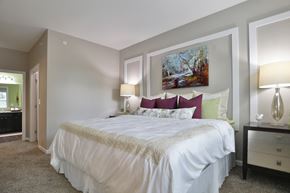 Fairborn apartment for rent - a bedroom with a white bed and a painting on the wall