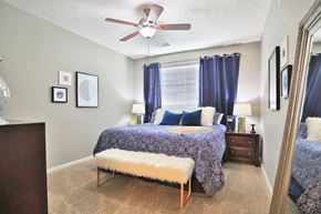 Greenwood apartment for rent - a bedroom with a bed and a ceiling fan