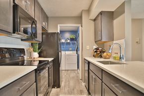Cincinnati apartment for rent - a kitchen with stainless steel appliances and white counter tops