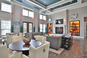 Jeffersontown townhouse for rent - A modern dining room with a wooden table and white chairs.