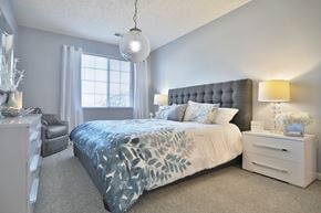 West Chester townhouse for rent - A bedroom with a large bed and a nightstand.