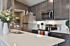 Beavercreek townhouse for rent - a kitchen with stainless steel appliances and a white counter top