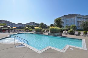 Louisville apartment for rent - A large swimming pool with a slide in the middle of it.