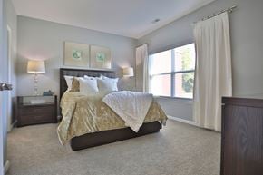 Louisville apartment for rent - A bedroom with a large bed and a window.