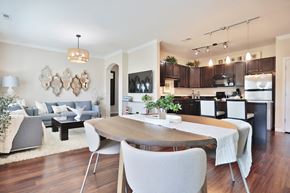 Louisville apartment for rent - A modern dining room with a wooden table and chairs.