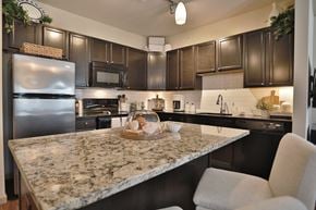 Mason townhouse for rent - a kitchen with stainless steel appliances and granite counter tops