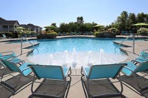 Mason townhouse for rent - a large swimming pool with blue lounge chairs around it